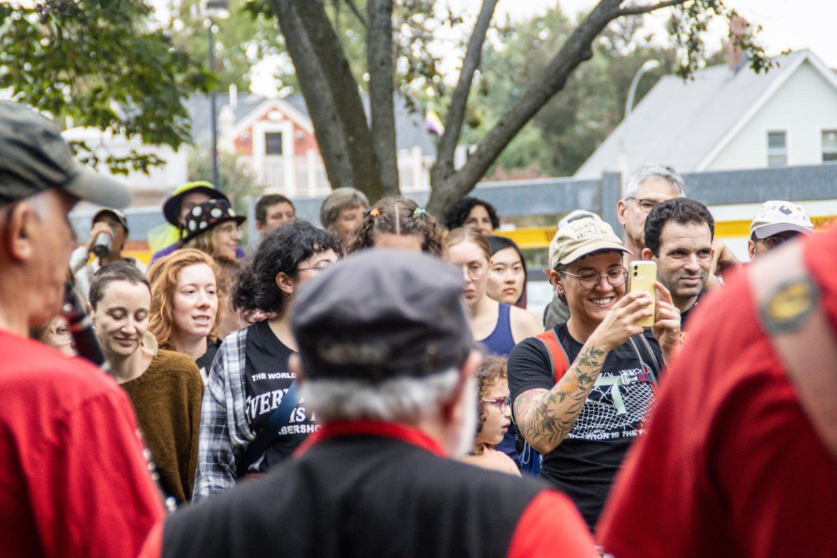Festival attendees film a band as it performs in Davis Square Park. Independent journalists, local news outlets and everyday festival-goers recorded performances with videos and photos throughout the day.