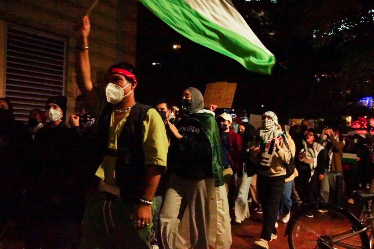 Protestors march across campus to show solidarity with Palestine. Many of the attendees wore masks to protect themselves from potentially being doxxed.