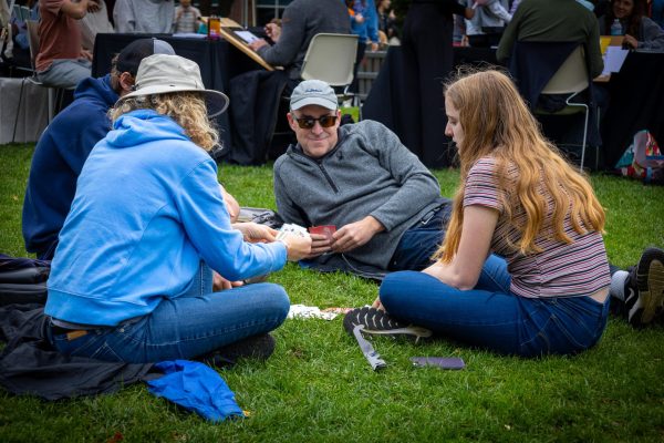 A family takes a break from the festivities on Centennial. The four played cards and spent time together along with many other families.