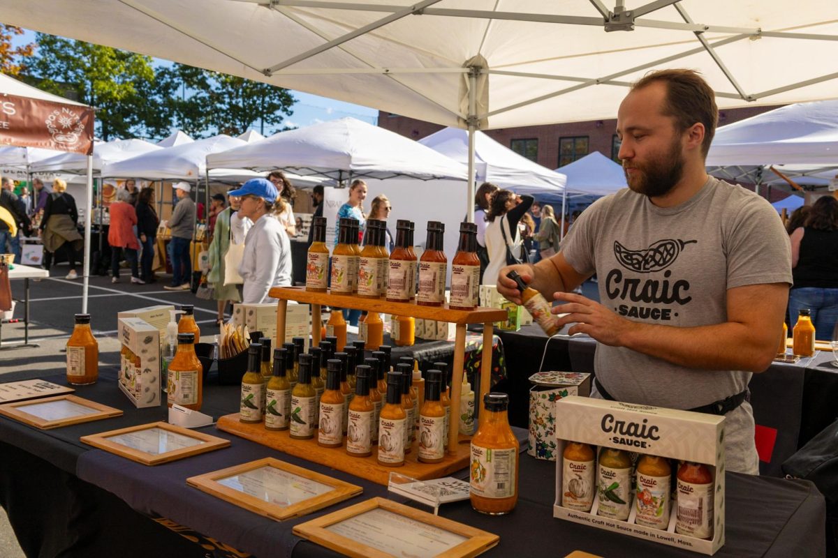 A local vendor restocks his display for Craic Sauce,a company that sells different flavors of hot sauces. Craic Sauce purchased 9000 peppers from 18 farms in Massachusetts, making them the biggest buyers of peppers in the state.