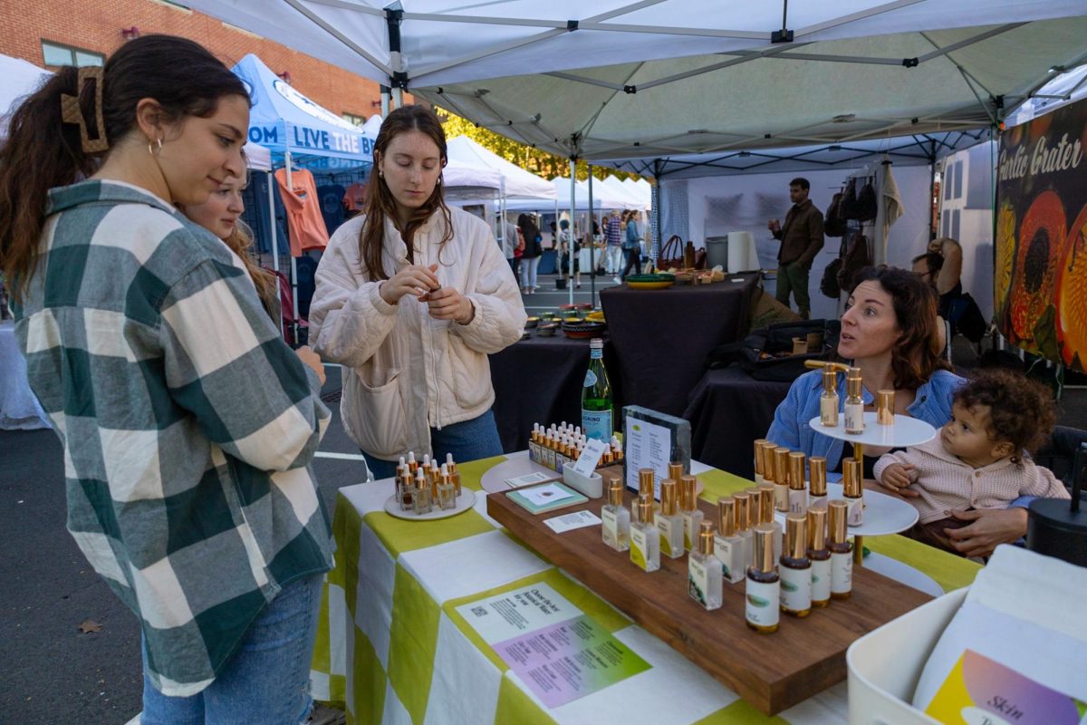 Herbalist Allie Cuozzo discusses her floral extracts with customers. Cuozzo started her business, Earth Allies,in California. SoWa Open Market was her first experience with promoting her brand on the East Coast.