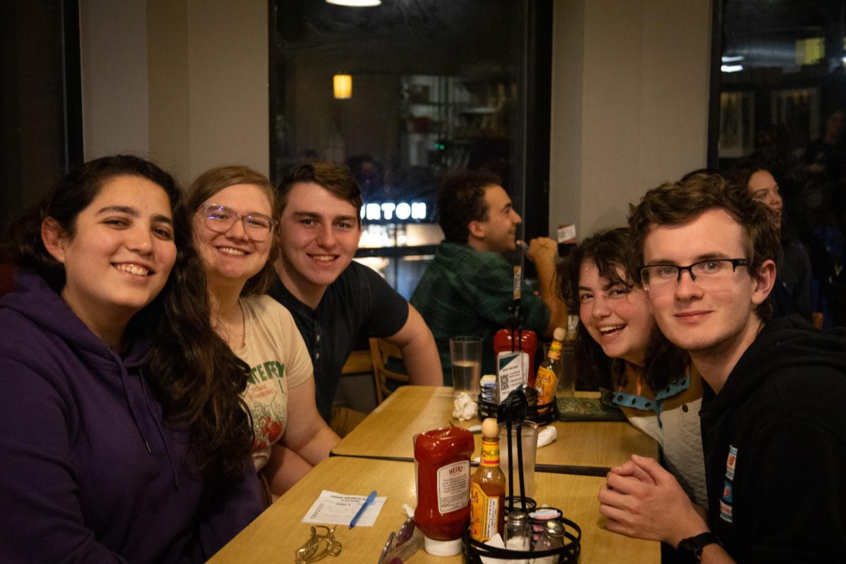 A group of friends pose for a photo at the end of Trident’s trivia night. They got in line an hour before the event started to ensure they got a seat.