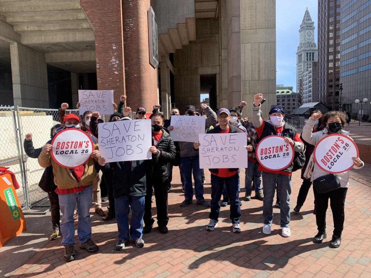 Members of the UNITE HERE Local 26 hold signs reading Save Sheraton Jobs. The union reversed its inital stance against the conversion of the Sheratons south tower into a residence hall. Photo courtesy UNITE HERE
