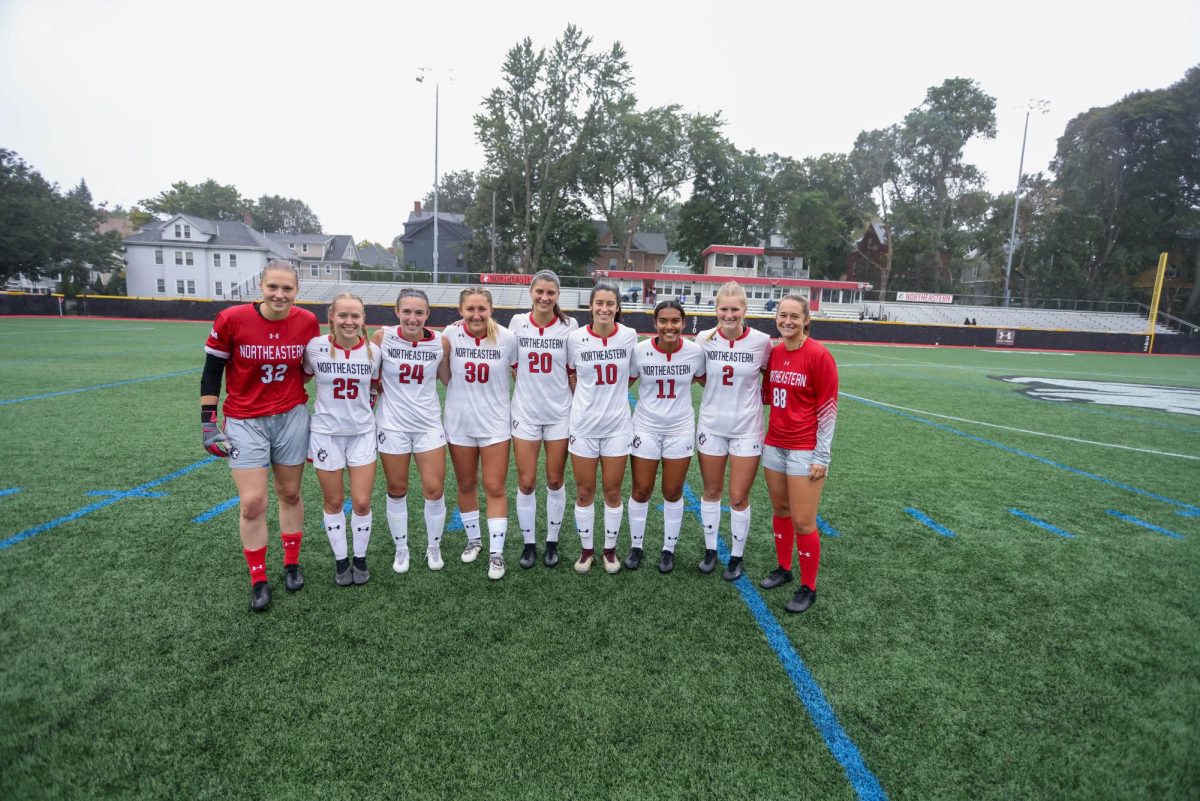 Seniors on the womens hockey team pose for a photo during the Senior Day celebration Sept. 24. Seniors Jessie Hunt and Gabby Scarlett scored during the game.