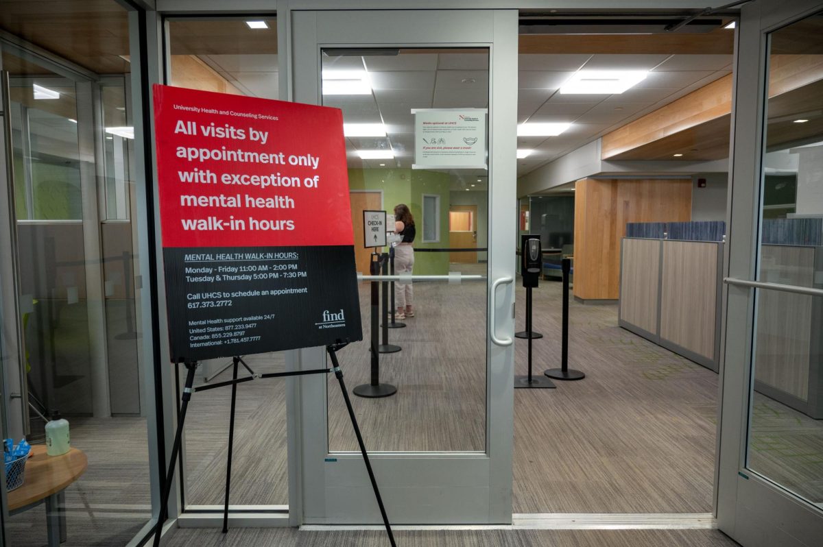 A sign telling people that visits are by appointment only, with the exception of mental health walk-in hours, stands at the entrance to UHCS. Many students have voiced concerns about the lack of resources from UHCS.