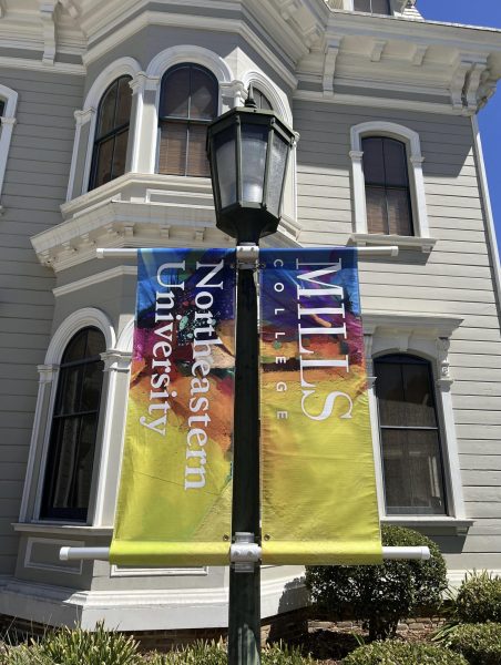 Two banners read Mills College Northeastern University. Former Mills College students found the settlement and the universitys response insufficient. Photo courtesy Jeta Perjuci. 
