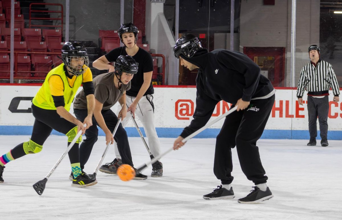 An+S+Ferrante+player+changes+the+direction+of+the+game+by+diverting+the+ball+toward+the+opposing+goal.+In+some+forms+of+broomball%2C+players+modified+brooms+using+scissors+and+duct+tape+to+fit+their+individual+playing+styles.