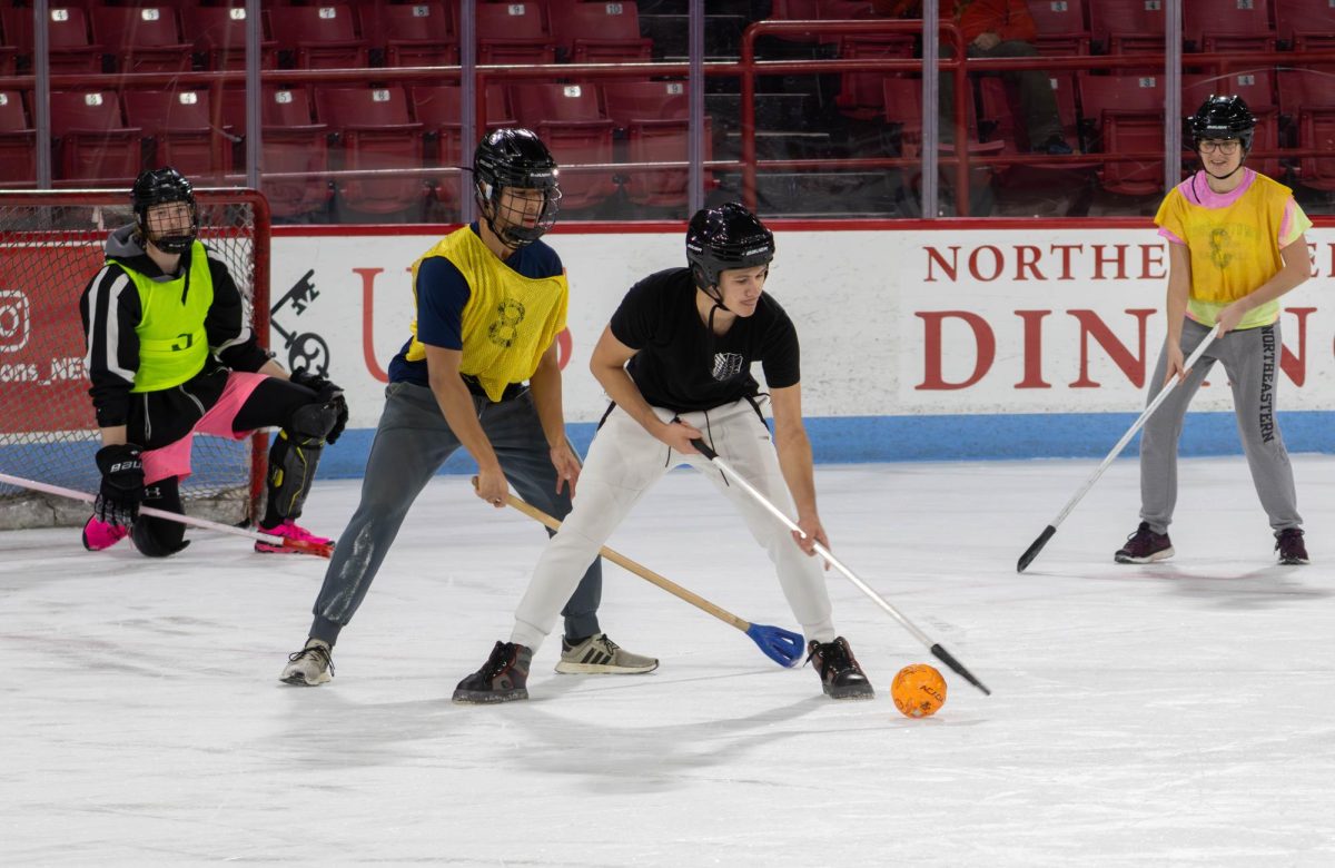 The Cherrybombs guard S Ferrante to prevent them from scoring. Northeastern started an all-gender broomball league to help students mingle and create camaraderie.