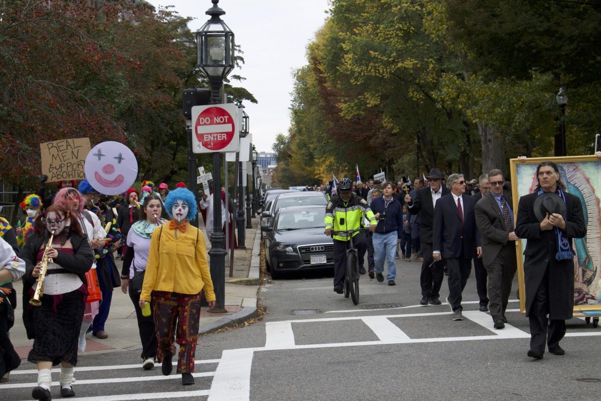 A group of clowns walks parallel to participants of the Boston Mens March. The clowns played music during their counterprotest to the anti-abortion organizations march.
