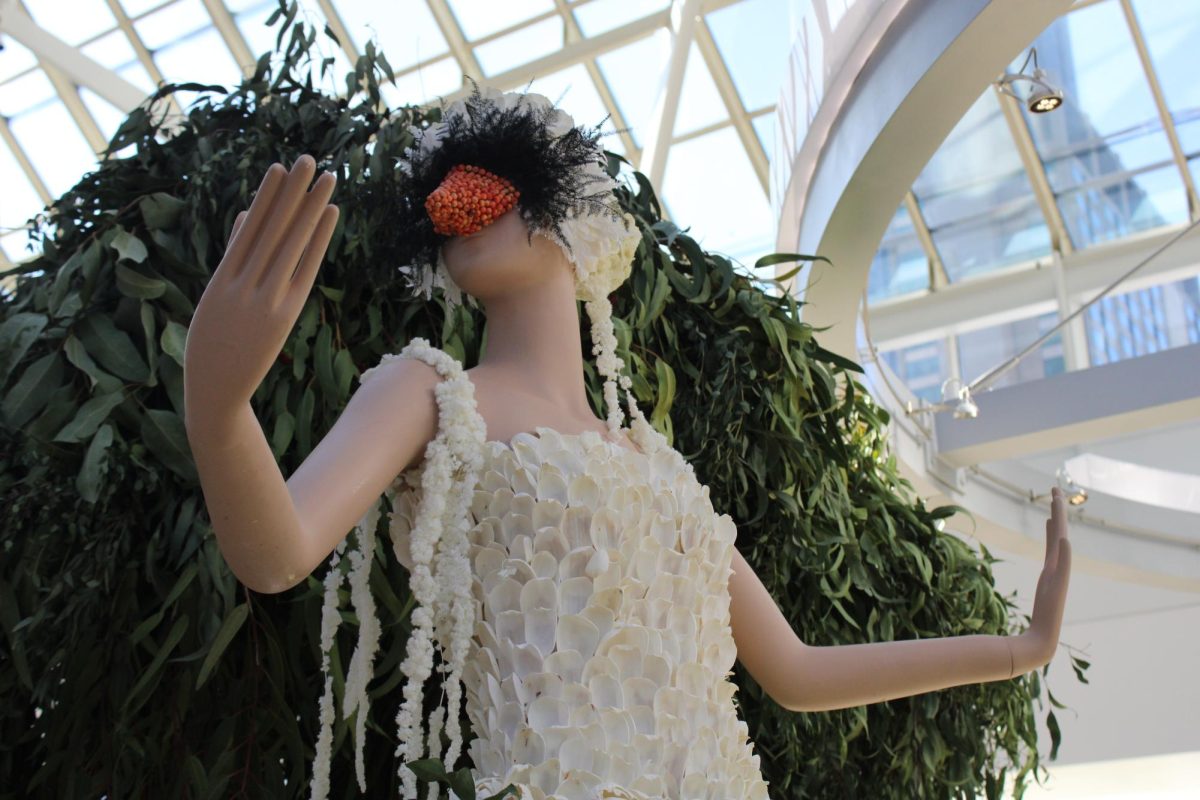 The mannequin representing Boston is designed like a swan, with a black and orange headpiece and white petals.
