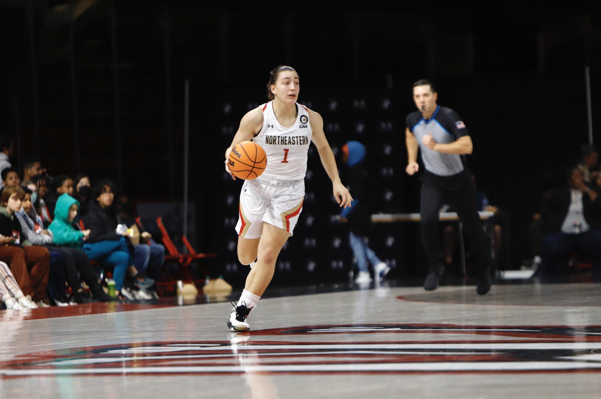 Senior guard Derin Erdogan dribbles the ball up the court. Last season, Erdogan led the Huskies in points per game (15), assists (125), and three-pointers (67).