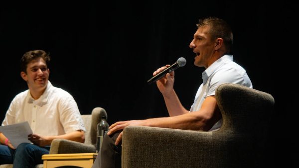 Rob Gronkowski speaks into a microphone while Brandon Korn sits and smiles besides him. Gronkowski visited Northeastern Nov. 8 as part of CUPs 2023 Homecoming events. Photo courtesy Olivia Watson, CUP.