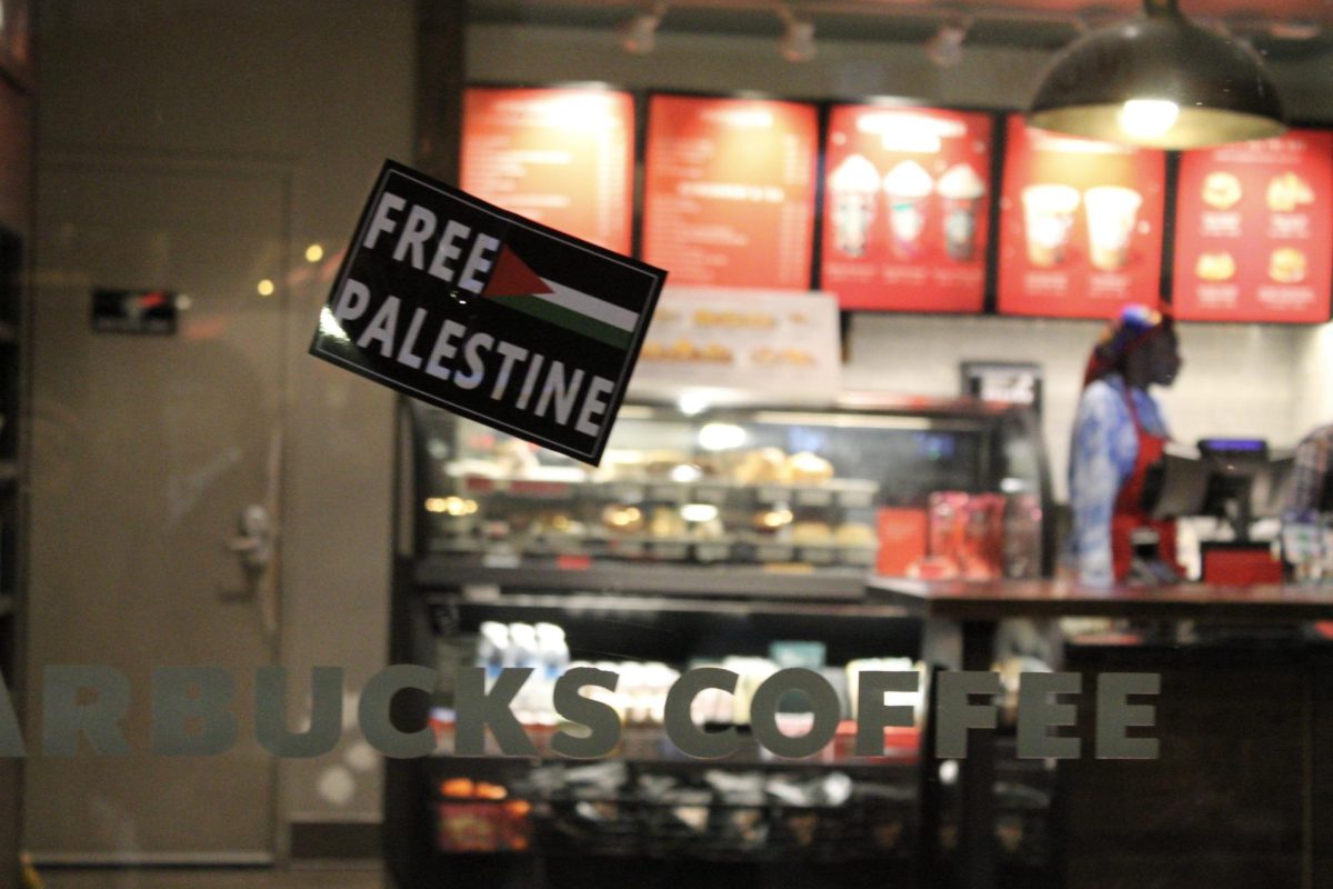 A “Free Palestine” sticker clings to a Starbucks location’s window. Grassroots demonstrators have encouraged the boycott of several U.S. companies, including Starbucks and McDonalds, as their corporate or Israeli-branches have voiced support for or donated to Israeli military offensives. 