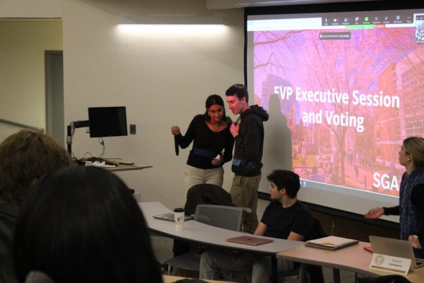 Shriya Thangada and Matt Coughlin receive applause from members of SGA after Coughlin is elected EVP. Thangada served as interim EVP until Coughlin won a majority of votes Nov. 7. 