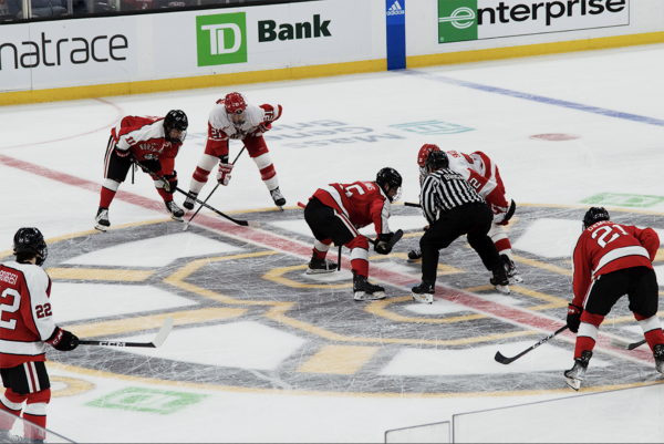 Forward Jack Williams takes a center ice faceoff at the 2023 Beanpot tournament. Northeastern defeated Boston University in the semifinals 3-1, then beat out Harvard for the championship title in a shootout. 