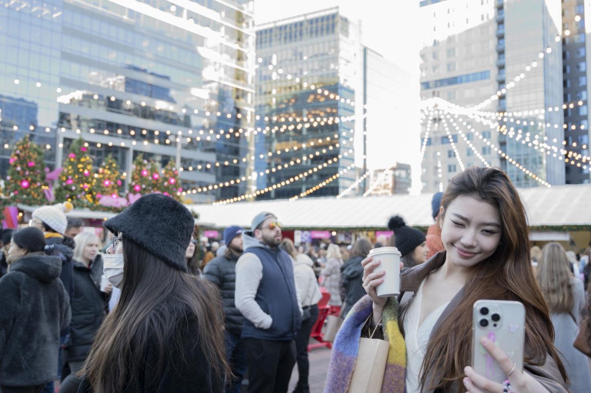 A shopper takes a selfie while holding up her drink. Social media photos and videos have made the market more popular.