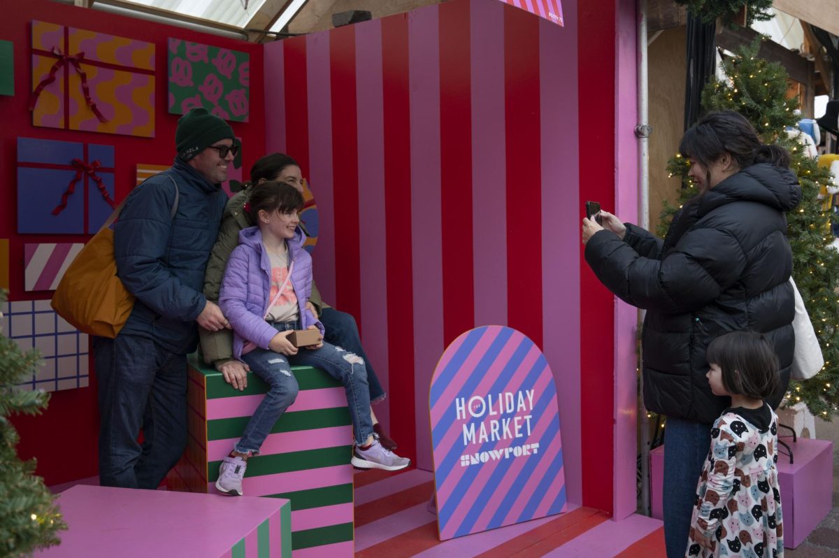 A family poses for a photo in the Snowport photo booth. Some vendors sold children’s toys, clothes and books.