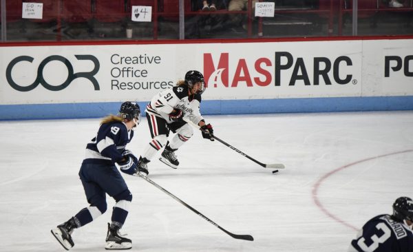 Graduate student forward Peyton Anderson brings the puck up the ice in a game earlier this season. Anderson tallied her first-ever hat trick in Saturday’s game against Holy Cross.