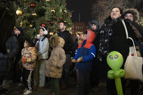 Children and adults watch the performances at the Faneuil Hall tree lighting Nov. 21.