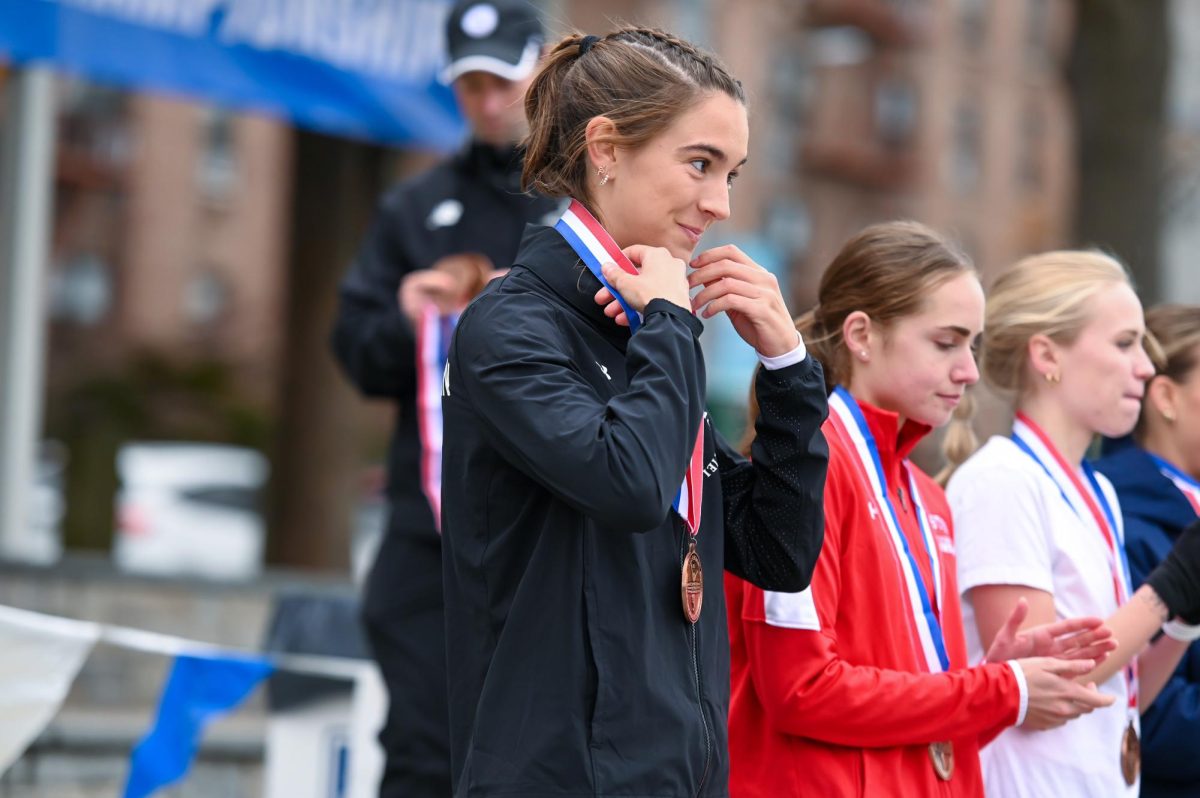 Abigail+Hassman+receives+a+medal+for+her+performance+at+the+NCAA+Northeast+Regional+Championships.+Hassman+claimed+fourth+place+in+the+womens+race+with+a+time+of+19%3A57.5.+Photo+courtesy+Northeastern+Athletics