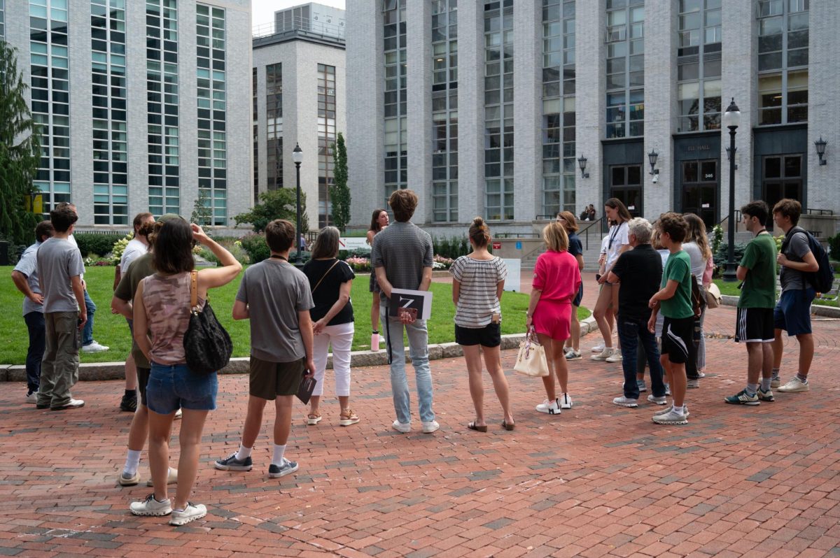 A group of prospective students and parents stop at Krentzman Quadrangle during an admissions tour. Northeastern received a record-breaking number of applications for fall 2024.