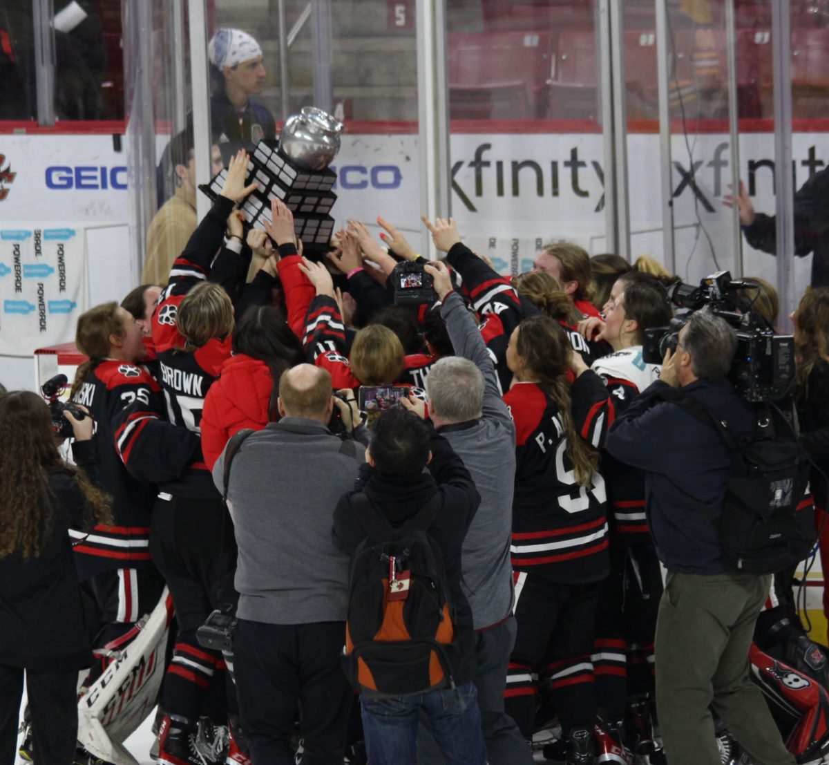 The Northeastern womens hockey team hoists the Beanpot trophy at the end of last years tournament. The Huskies beat BC 2-1 in the championship to claim the title. 
