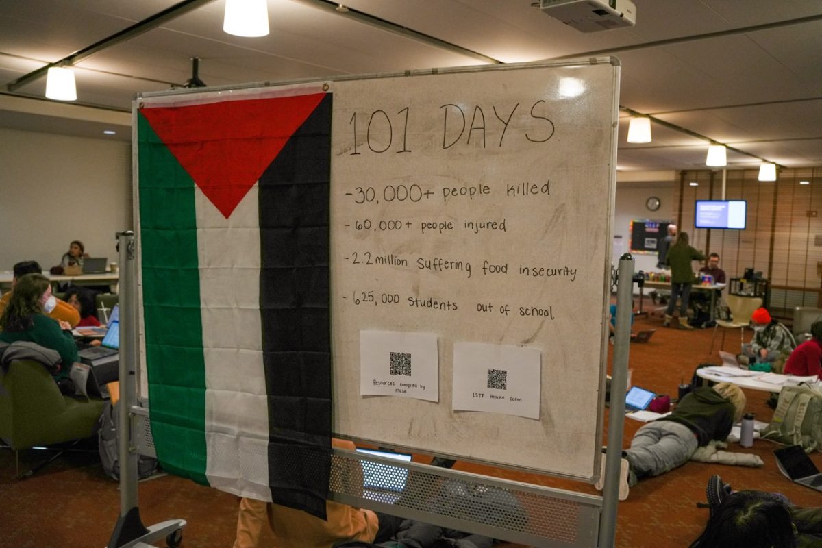 A+white+board+with+a+Palestinian+flag+lists+statistics+from+the+first+101+days+that+Israel+has+been+at+war+with+Hamas.+Over+60+students+attended+the+NUSL+SJP+10-hour+sit-in+Jan.+16.
