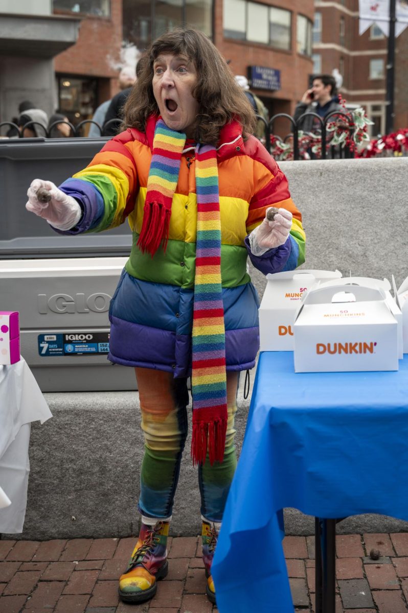 A woman dressed in an all-rainbow outfit excitedly hands out Dunkin’ munchkins during the 13th annual Taste of Chocolate Festival in Harvard Square Jan. 27. Read more here. 