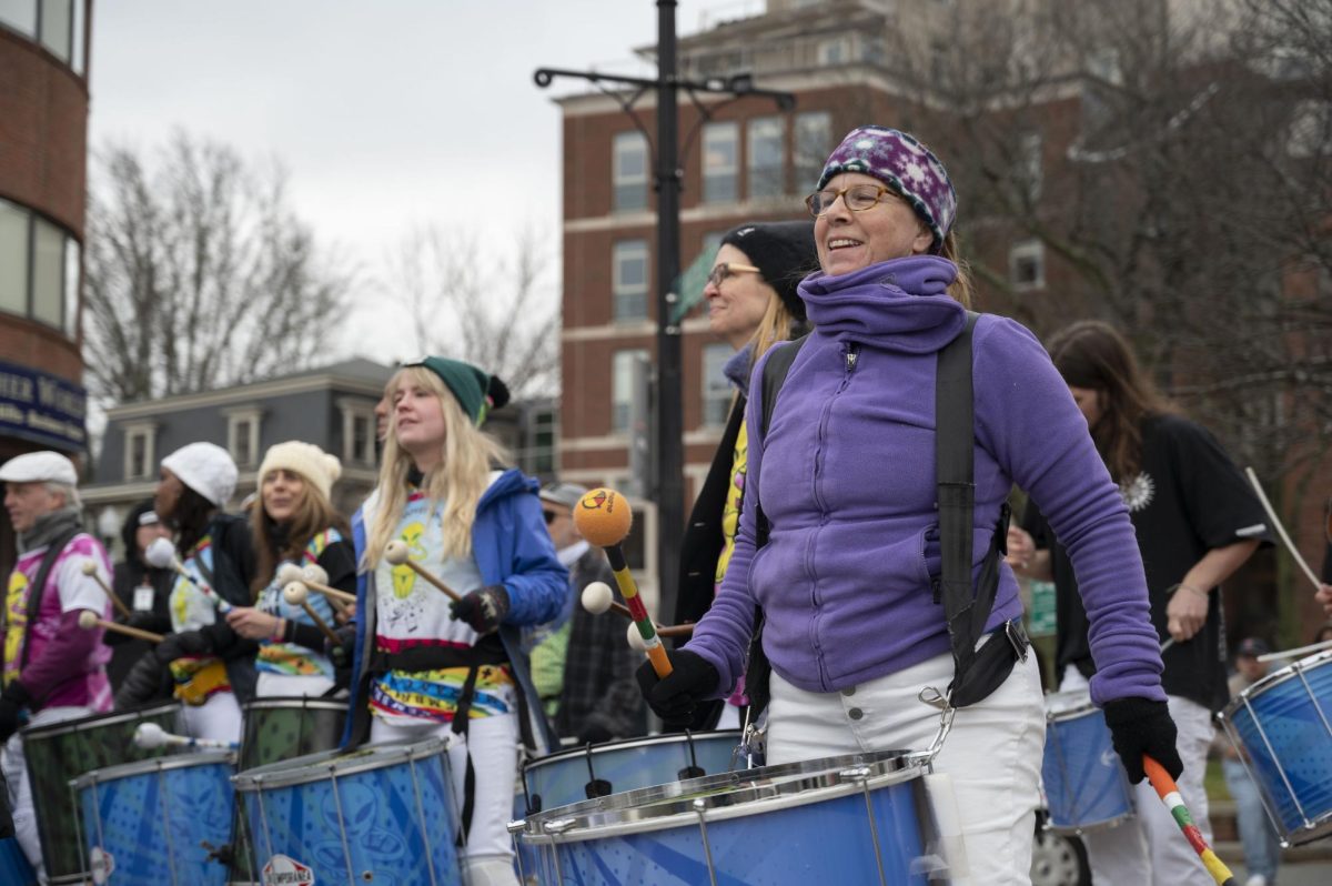 A member of Grooversity smiles while playing the drums. The group was founded in part with a focus on community outreach and has performed at many events like the Taste of Chocolate Festival.