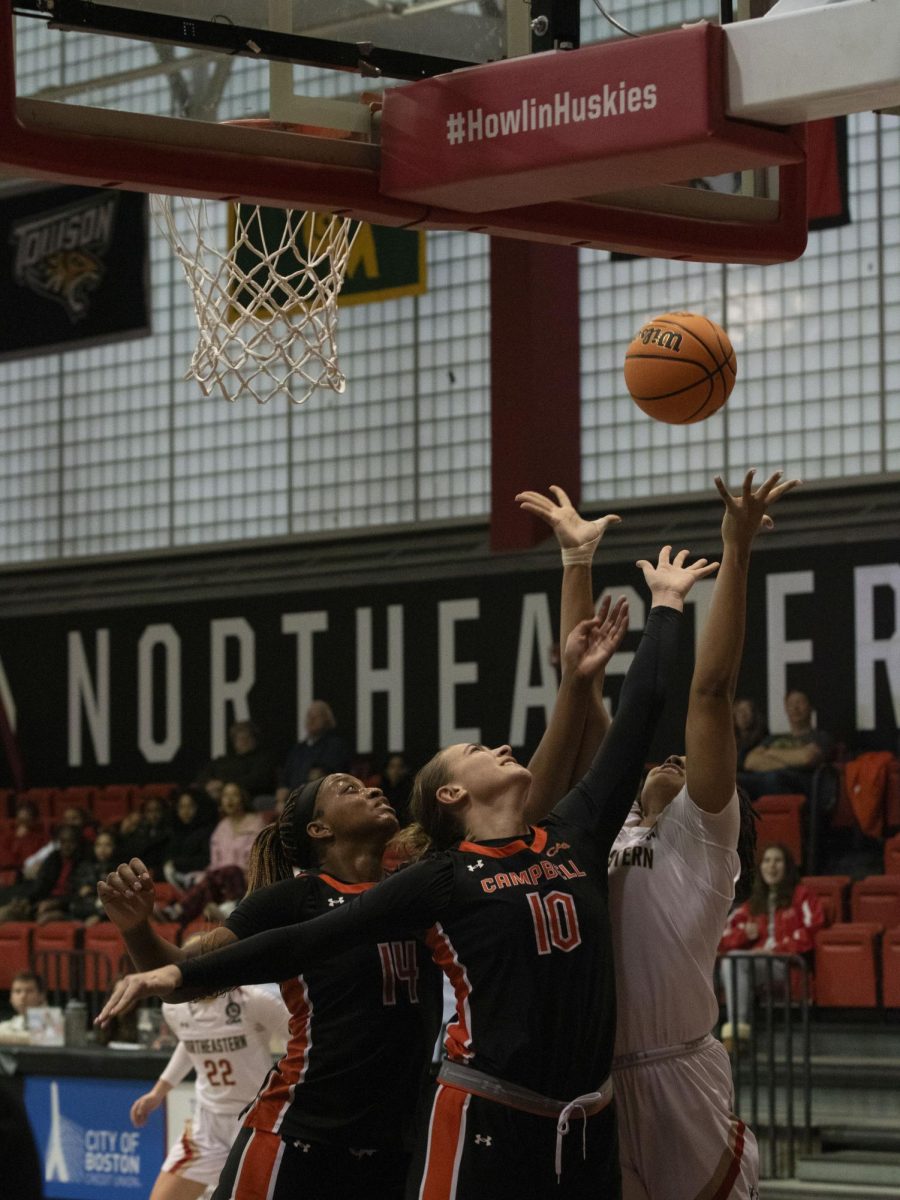 Northeastern and Campbell forwards reach for the ball Jan. 28.