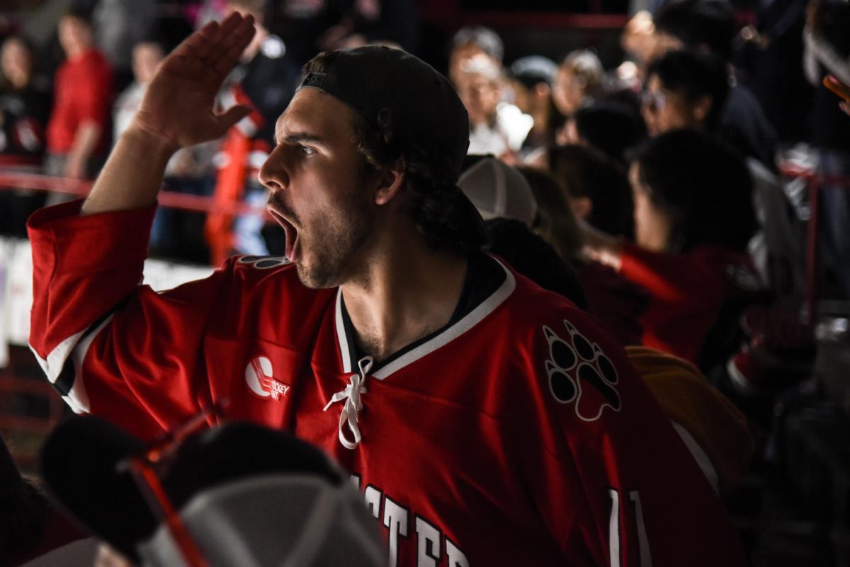 A DogHouse member chants passionately at the action on the ice at Matthews Arena. The DogHouse often shouted the word sieve at opposing goaltenders, indicating they allowed too many goals into the net.