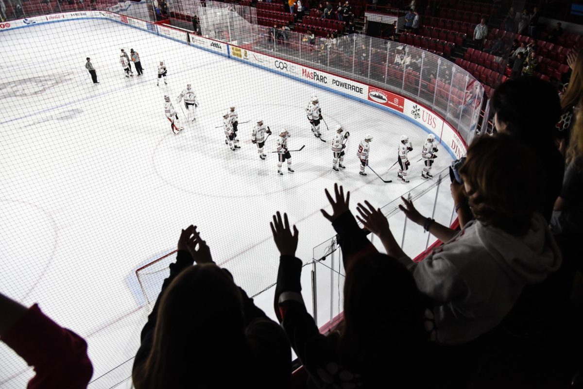 The DogHouse waves at the Northeastern men’s hockey players in appreciation as they exit the ice after a shutout win. When exiting, the players tipped their sticks to acknowledge the fans and thanked them for their passion and support.