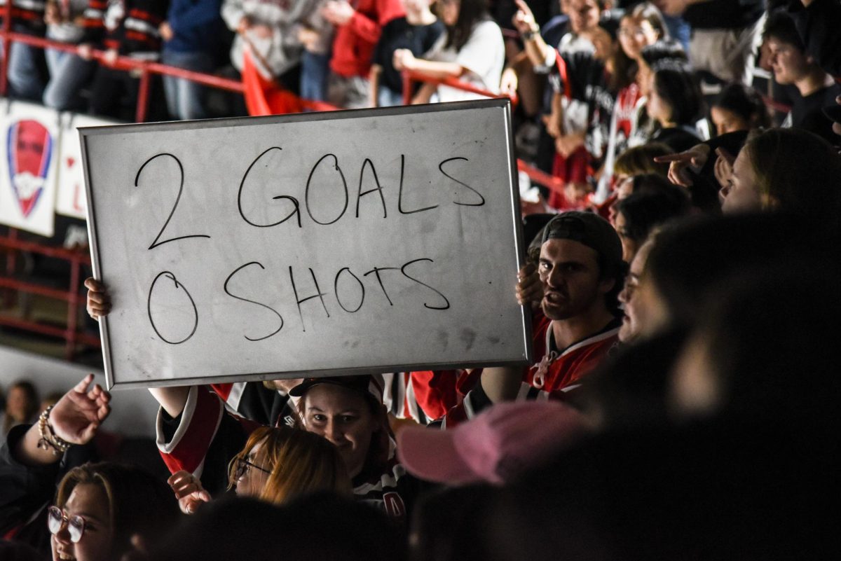 A fan holds up a whiteboard emphasizing the Northeastern’s domination over its opponent. The section frequently used antics like this in other games as a way to heckle other teams and boost morale.