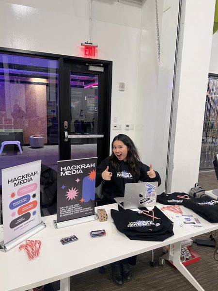 Shirley Wang poses for a photo while tabling at a networking and holiday marketplace event in fall of 2023. Wang founded Hackrah Media as an inclusive Gen Z-led marketing agency. Photo courtesy Shirley Wang.