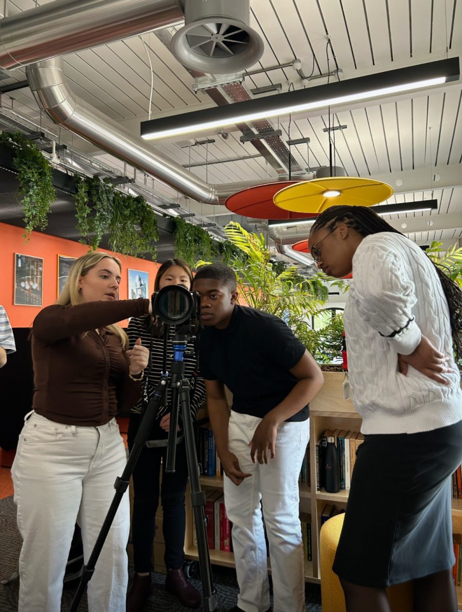 Clara McCourt points at the camera display while Mimi Freund, Daniel Rateau and Kaia Reed look on. The documentary was nominated for an award at the Garden State Festival and has been submitted for a student Emmy. Photo courtesy Clara McCourt.
