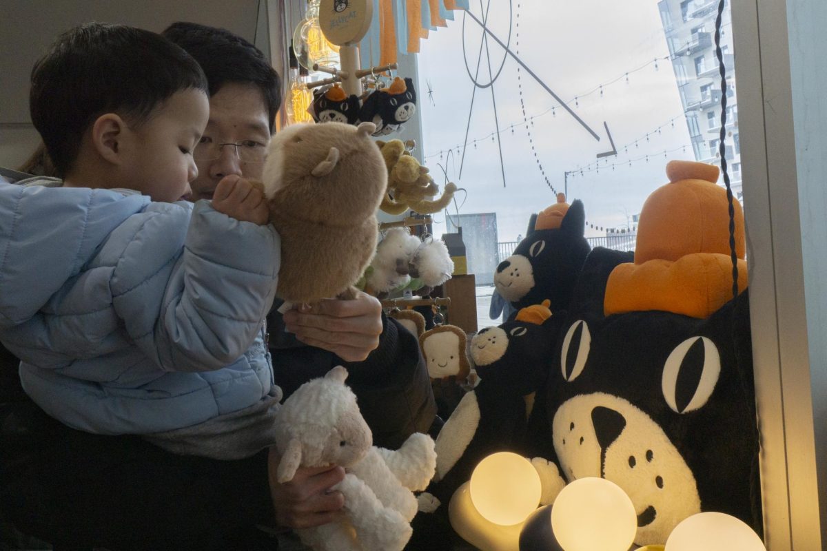 A father and son pick out a Jellycat together. Many children attended the event with their parents.