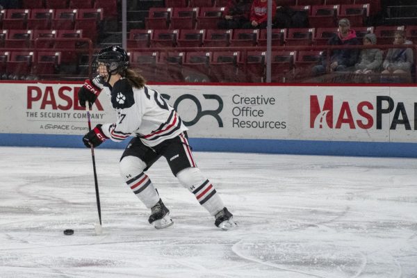 Megan Carter takes the puck down the ice for Northeastern. Carter took a big hit during a penalty kill in Northeasterns Friday night game against Vermont. 