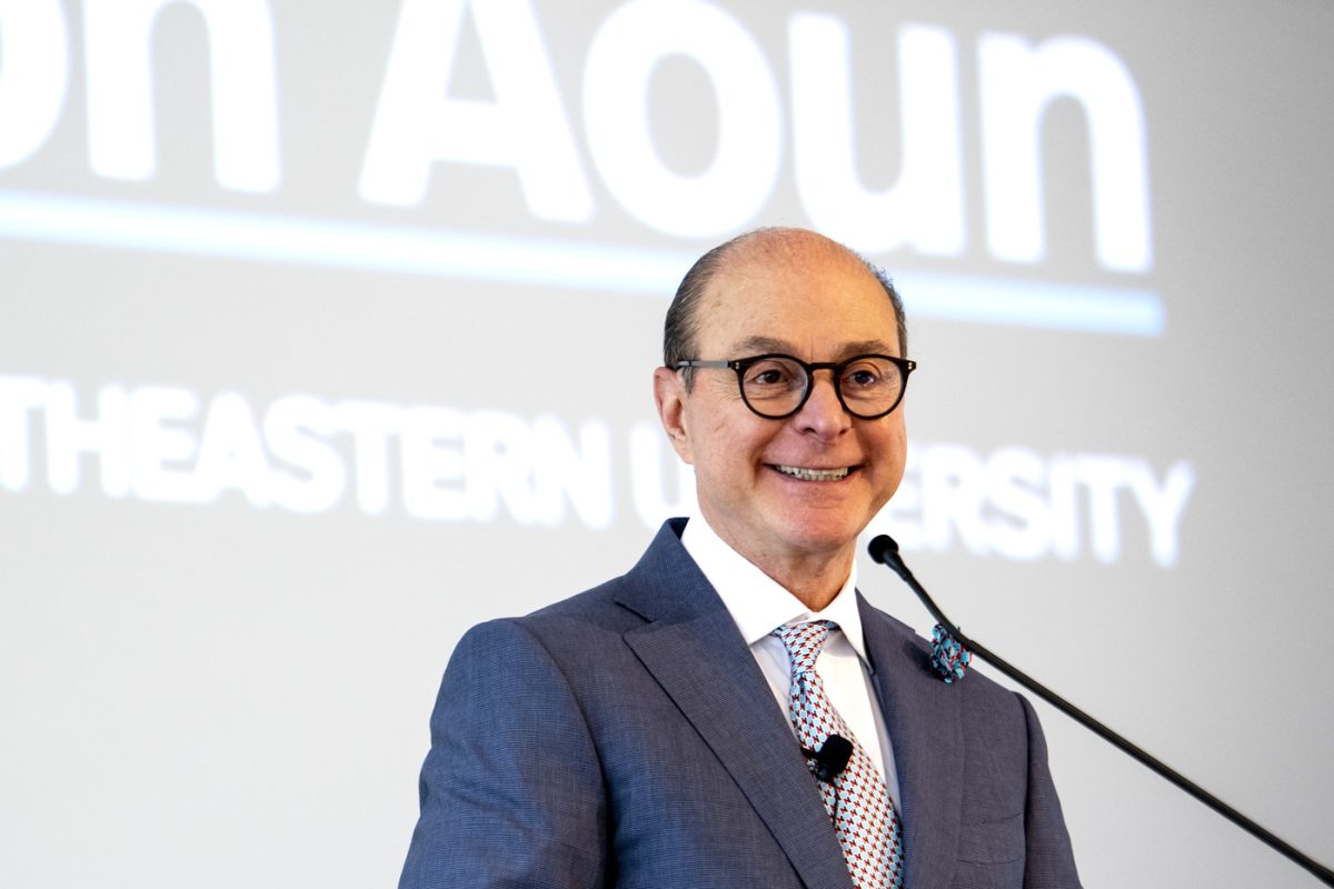 President Aoun smiles for a photo in front of a microphone. Aoun was the eighth highest-paid private college president in the U.S. during FY 2022 with a total compensation of roughly $2.7 million. Photo courtesy Ruby Wallau, Northeastern University.