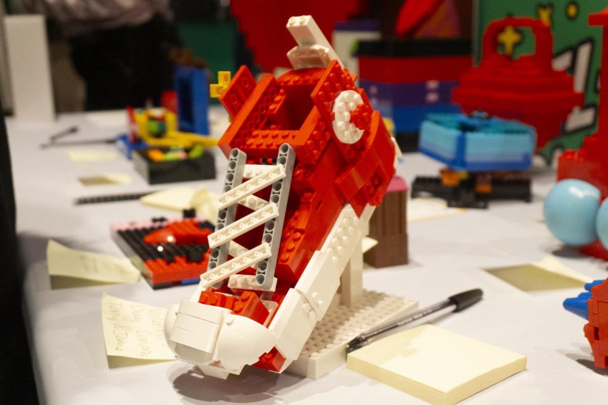A Lego model of a red Converse shoe sits on the Big Build table for judging. Judges carefully inspected and took notes on each model and before announcing the shoe as the first place winner.