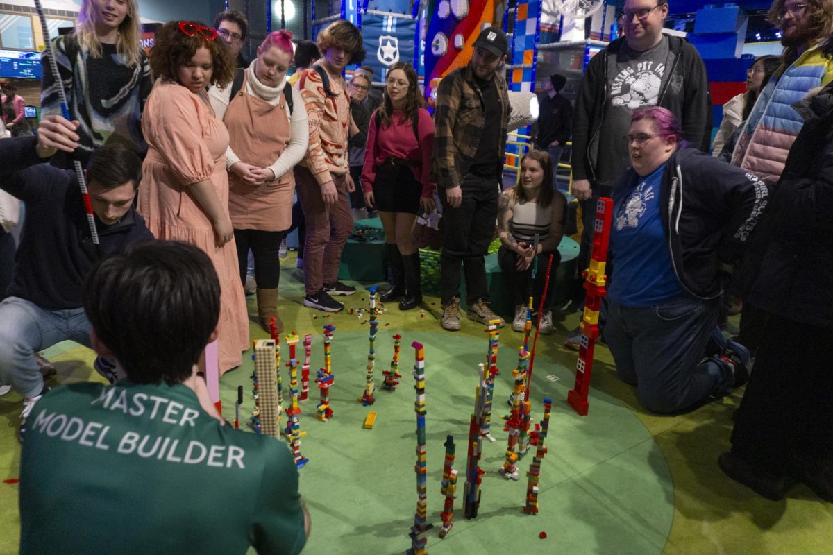 A master model builder for LEGO Discovery Center judges the Tallest Tower Challenge. Towers that were not freestanding were disqualified from the competition.