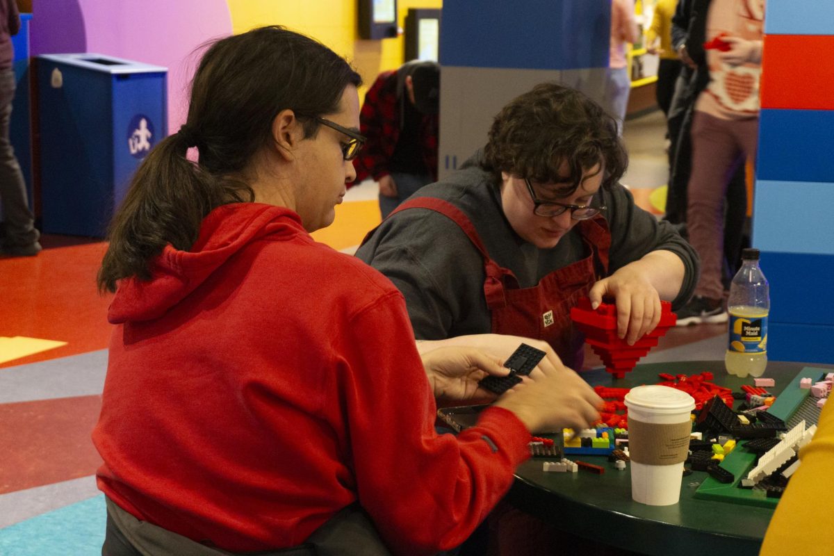 A couple builds a red Lego heart to be entered into the Big Build. Many of the builds incorporated hearts or symbols of love.