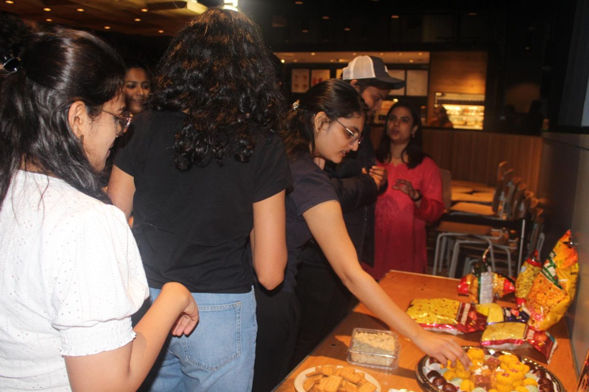 After an intense workout, participants sample an assortment of classic Indian snacks. Funding for this event was provided by the OGS to promote cultural celebration on campus.