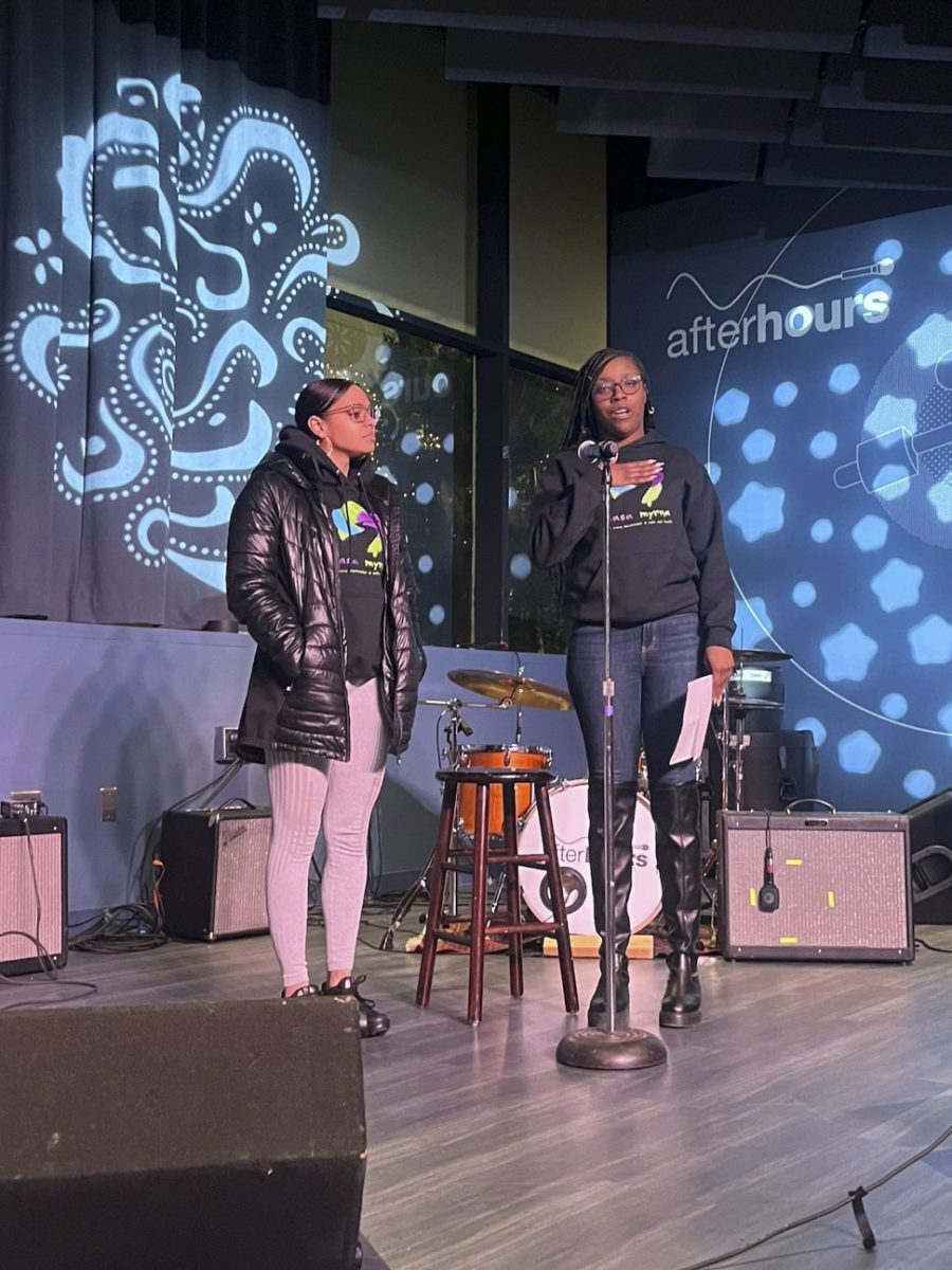 Two representatives from Casa Myrna speak to attendees about the organization and safe relationship practices. Casa Myrna accepted donations throughout the event. Photo courtesy Haylen Wehr.