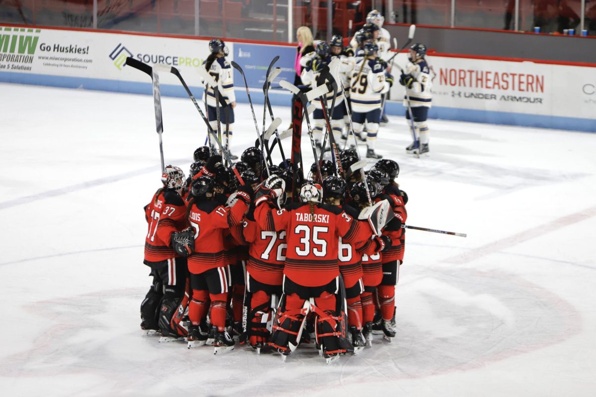 The Northeastern womens hockey team celebrates a victory on home ice. Northeastern defeated UNH Wednesday night in the Hockey East semifinals. 