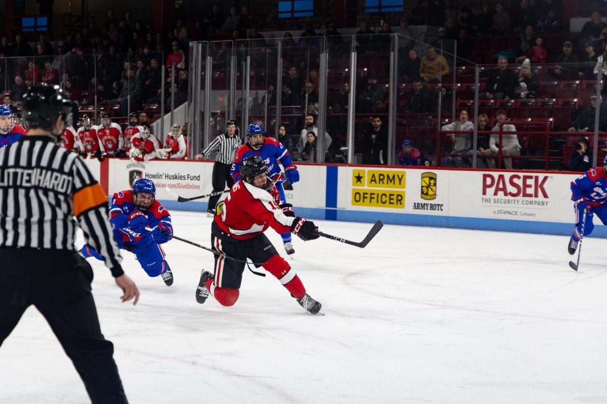 Jack Williams takes a shot against Lowell. Williams tallied a goal and an assist against the River Hawks Feb. 17.