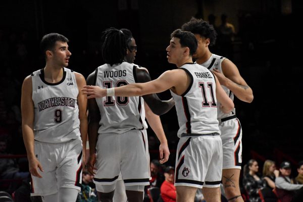 The Huskies group together during their game against Hampton Feb. 24. Northeastern finished the season with a 12-20 overall record.