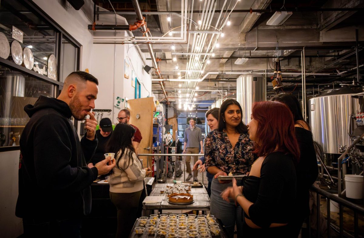 Baking competitors and guests try pies in a fenced-off section of the brewing facility. Lamplighter manufactured and offered creatively-named beers such as Night Cap, Margot and Treacle Tart during the event.