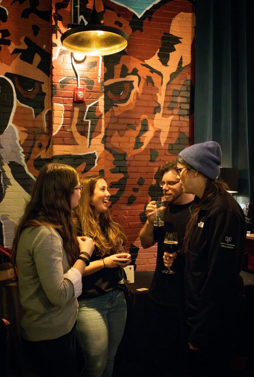 Guests and pie bakers alike gather and chat after the announcement of the winner, enjoying the atmosphere and their drinks. Many stayed after the competition and conversed or moved to the primary bar area as employees closed down the taproom for the night.