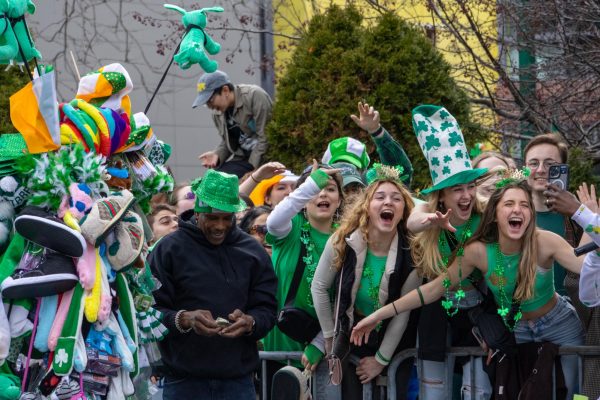 Parade spectators cheer while dressed in green clothing and shamrock bead necklaces. An estimated 1 million people were in South Boston for the parade.