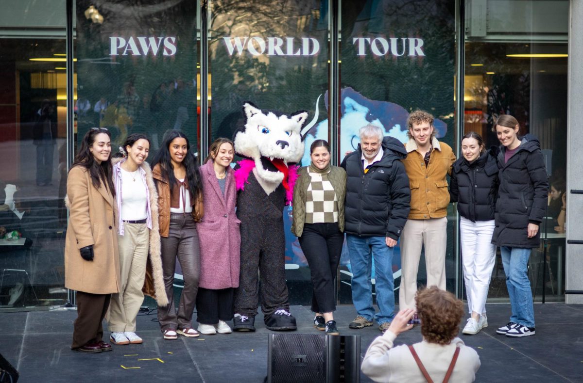Paws and presenters of the “Paws World Tour” pose for a picture on stage in Snell Quad. Besides Paws, the SOAL Step Team, the Unisons, the NU Irish Dance Club, the New England Bhangra Club and NU Aaroh performed, entertaining passersby and lifting their spirits during Wellness Week.